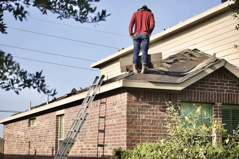 Professional roofer working on a residential roof in Vaught Estates